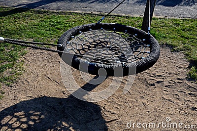 Swing trains stability at the children`s rope center, playground for schoolchildren. A very torn net must be repaired or replaced. Stock Photo