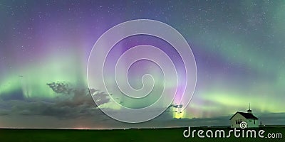 Swirl of Aurora Borealis Northern Lights over the historical North Saskatchewan Landing school Stock Photo