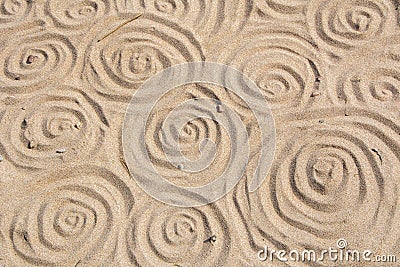 Swirl pattern on the sand. Hand drawn swirls on the sandy beach Stock Photo