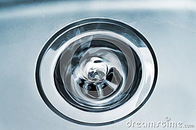 Swirl water in a drain Stock Photo