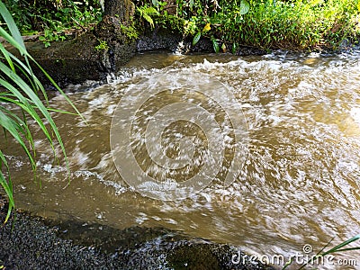 Swirls and streams of turbid water Stock Photo