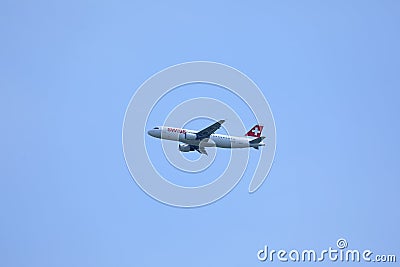 Swiss airline flying up in the blue sky Editorial Stock Photo