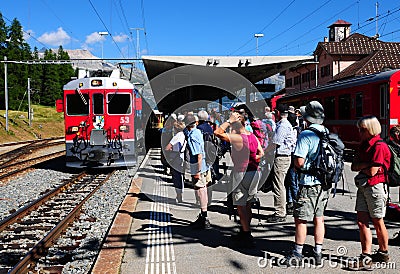 Swiss alps: Hikers at the train station in Pontresina in the upper Engadin Editorial Stock Photo
