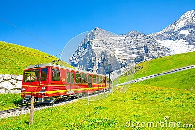 Swiss Alps and Jungfraubahn red train, Switzerland Editorial Stock Photo