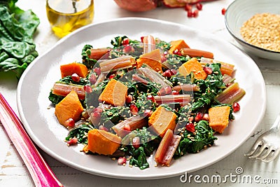 Swiss chard with sweet potato and pomegranate Stock Photo