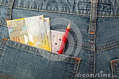 Swiss money and lottery bet slip in pocket Stock Photo