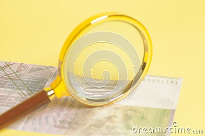 Swiss one thousand 1000 Franc banknotes under magnifying glass Stock Photo