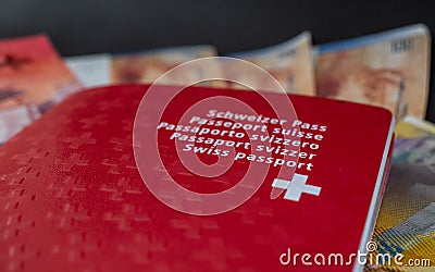 Swiss passport and money close up on black background switzerland citizenship Stock Photo