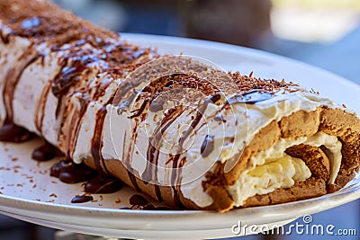 swiss roll Slices of sweet cream roll on a cutting board Stock Photo