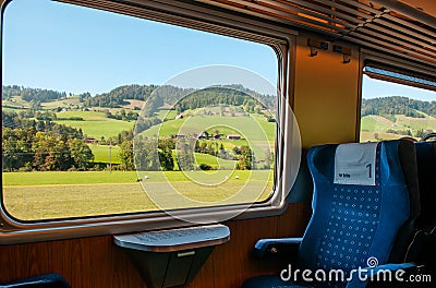 Swiss rural farmland through train window, Train travel concept Editorial Stock Photo