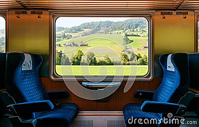 Swiss rural farmland through train window, Train travel concept Editorial Stock Photo