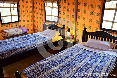 Swiss tent interior with two comfortable beds and lantern, Stock Photo