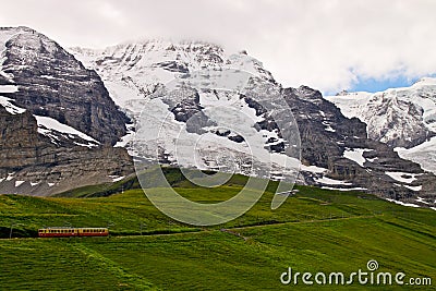 Swiss train climbing up Alps Stock Photo