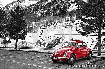 Swiss winter, parking lot by the Alps, red beetle car, beautiful snow mountain Editorial Stock Photo