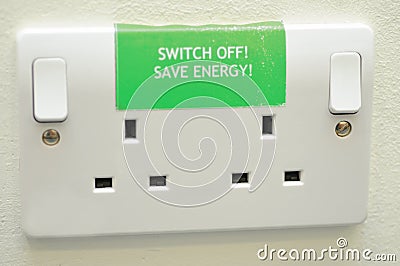 Save energy sign on plug sockets Stock Photo