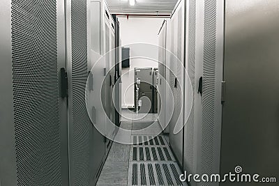 Switchgear room with raws of cabinets with network or cellular hardware Stock Photo