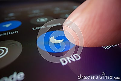 Switching smartphone to do not disturb mode Stock Photo