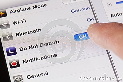 Switching to do not disturb mode on an iPad Editorial Stock Photo