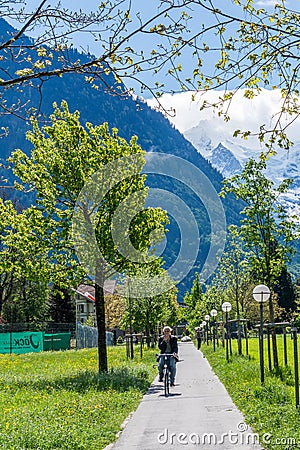 Switzerland, enjoying the sun riding a bicycle and a stunning view Editorial Stock Photo