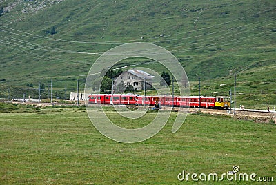 Switzerland: July 2012, Red Alpine Train Bernina Express from St.Moritz to Tirano near Bernina Pass in Switzerland Editorial Stock Photo