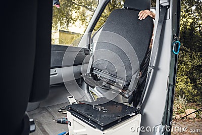 Swivel seat getting installed in a camper van Stock Photo