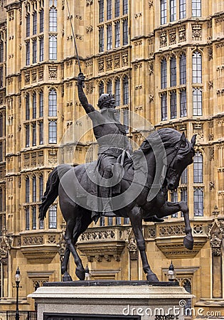 Sword raised in the air astride a prancing horse. Editorial Stock Photo