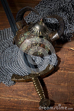 Sword and the soldier's helmet with horns on a wooden background Stock Photo