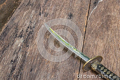 Sword steel blade samurai ancient on old wooden surface floor with copy space Stock Photo