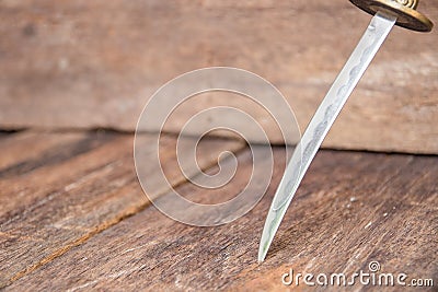 Sword steel blade samurai pierce on old wooden surface floor with copy space Stock Photo