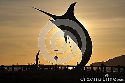 Swordfish Marlin statue located on small roundabout Kota Kinabalu seafront with sunlight of sunset time for malaysian people and Editorial Stock Photo