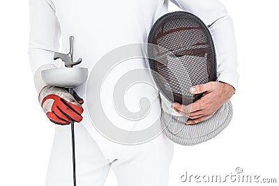 Swordsman holding fencing mask and sword Stock Photo