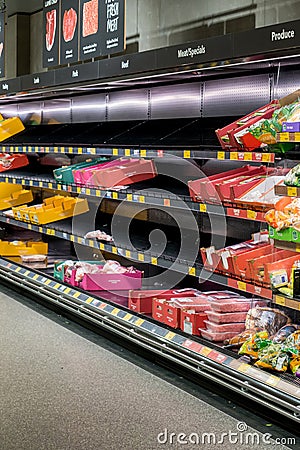Half empty meat aisle shelf at Aldi Supermarket. Meat shortage due to COVID-19 Omicron outbreak in Editorial Stock Photo