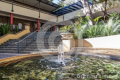 Running water from a fountain, tucked in a quiet corner of a modern building block Editorial Stock Photo