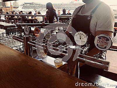 SYDNEY, AUSTRALIA - OCTOBER 3, 2018: Multiple brand draft beer dispenser and liquor bottle and many Whiskey at the Darling Harbour Editorial Stock Photo