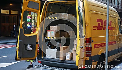 DHL express delivery car close up shot with open back doors, cardboard parcel boxes on shelves being visible Editorial Stock Photo