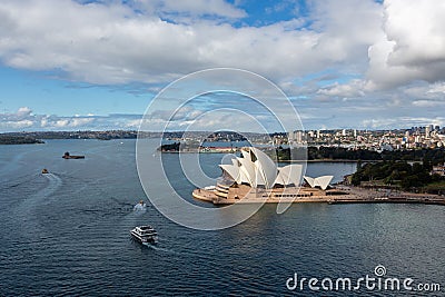 Sydney Opera House and ferry boats on a sunny day, view from the Harbour Bridge tower in Sydney Editorial Stock Photo