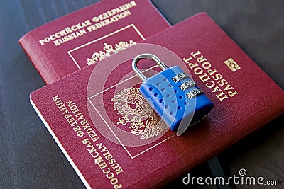 Symbol of anti-Russian sanctions. Two Russian passports locked to padlock Stock Photo