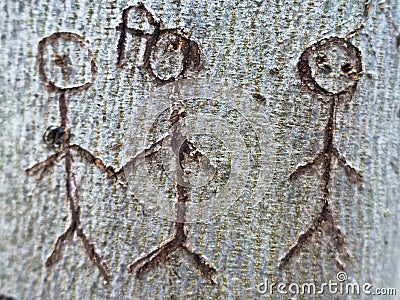 Symbol of a group of people carved in tree Stock Photo