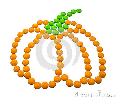 Symbol Halloween - a pumpkin. Composed of small round candies. Stock Photo