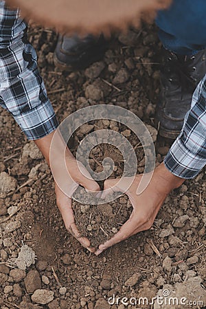 Symbol heart earth day. Handful of dirt hands heart shape. Farm organic earth. Farmer hands soil ground earth dirt garden soil Stock Photo