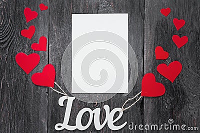 White letters Love with ropes and with red hearts, like balloons. space for text on a white sheet of paper. Stock Photo