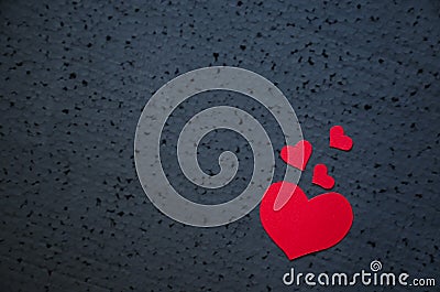 Symbol of love and valentines day background - bright red hearts on a black background. Love concept Stock Photo