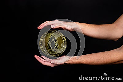 The symbol of the new popular cryptocurrency eosio with the image of hands Stock Photo