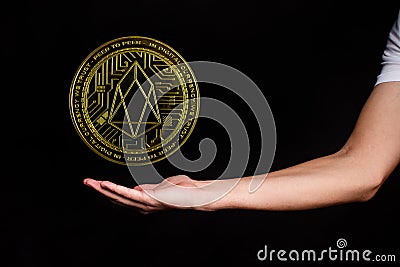 The symbol of the new popular cryptocurrency eosio with the image of hands Stock Photo