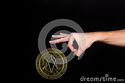The symbol of the new popular cryptocurrency eosio with the image of hands Stock Photo