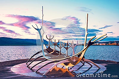 Symbol of Reykjavik, famous sculpture Sun Voyager viking ship on the seafront on harbor of Iceland`s capital Reykjavik against Editorial Stock Photo