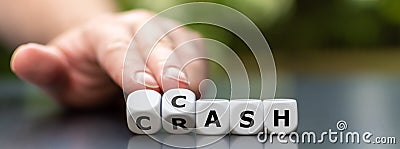 Symbol for selling stocks before a crisis. Hand turns dice and changes the word crash to cash Stock Photo