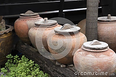 Symbol of several jars with wooden lids on top Stock Photo