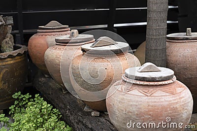 symbol of several jars with wooden lids on top Stock Photo