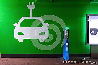 Symbol sign of electric cars charging station. Plug-in charger or socket for PHEV cars or vehicles. Concept of green electricity, Editorial Stock Photo